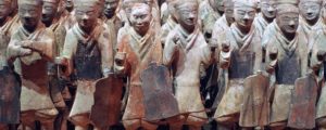 Clay statutes of Chinese martial artists and soldiers in various postures.